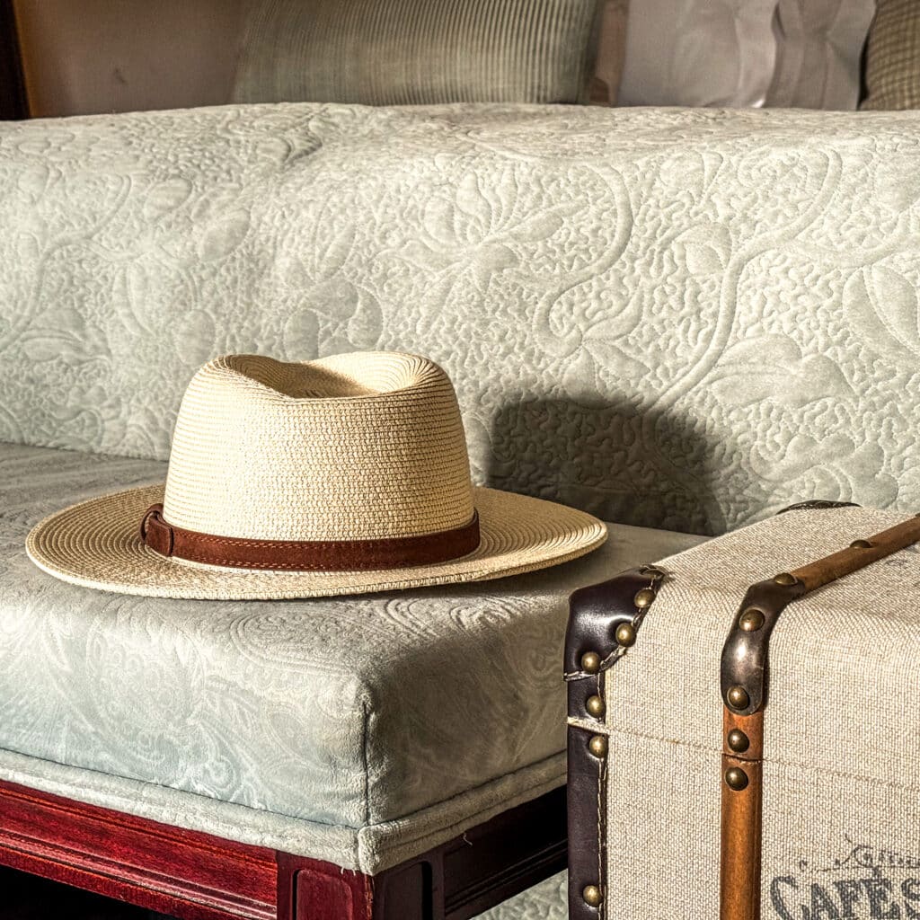 A safari hat on a bed in a luxury safari lodge in South Africa.
